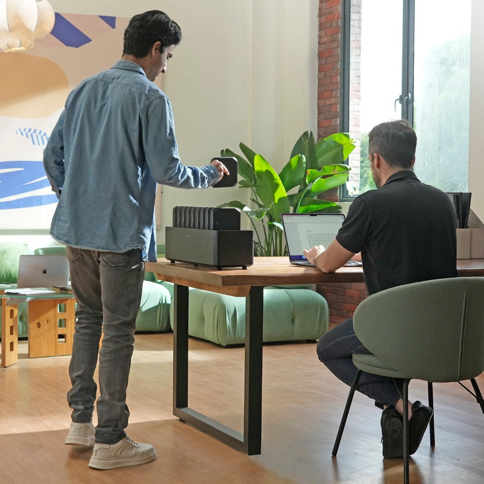 Colleagues collaborating in an open office with an Omni Power Station