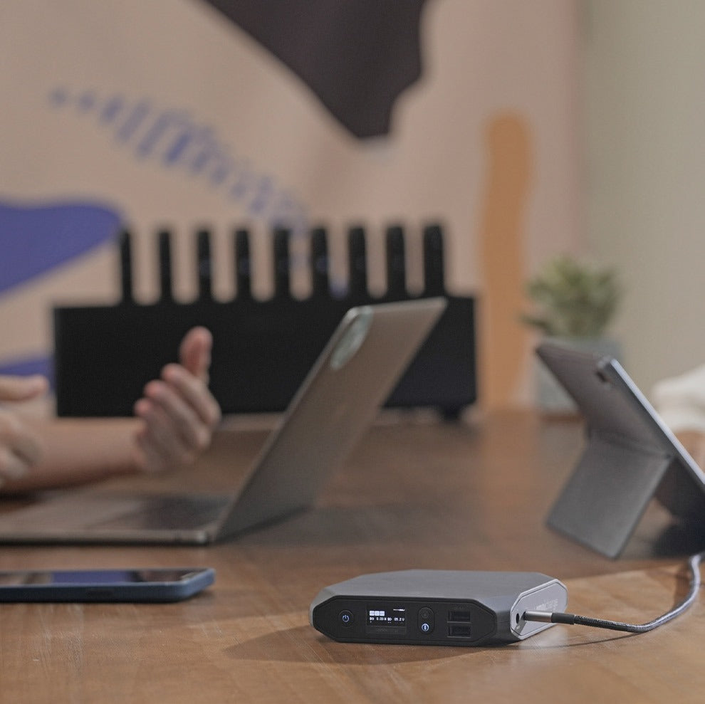 Omni power bank charging a laptop and tablet
