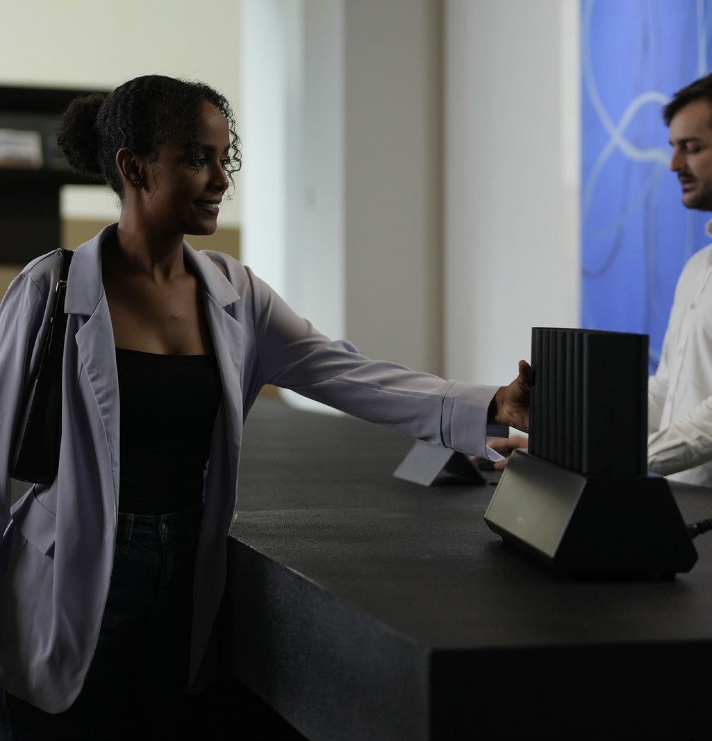 Employee checking out a power bank from the Omni Power Station