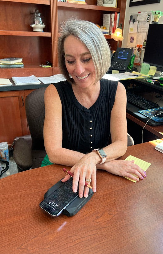 NSU staff member using a power bank at her desk